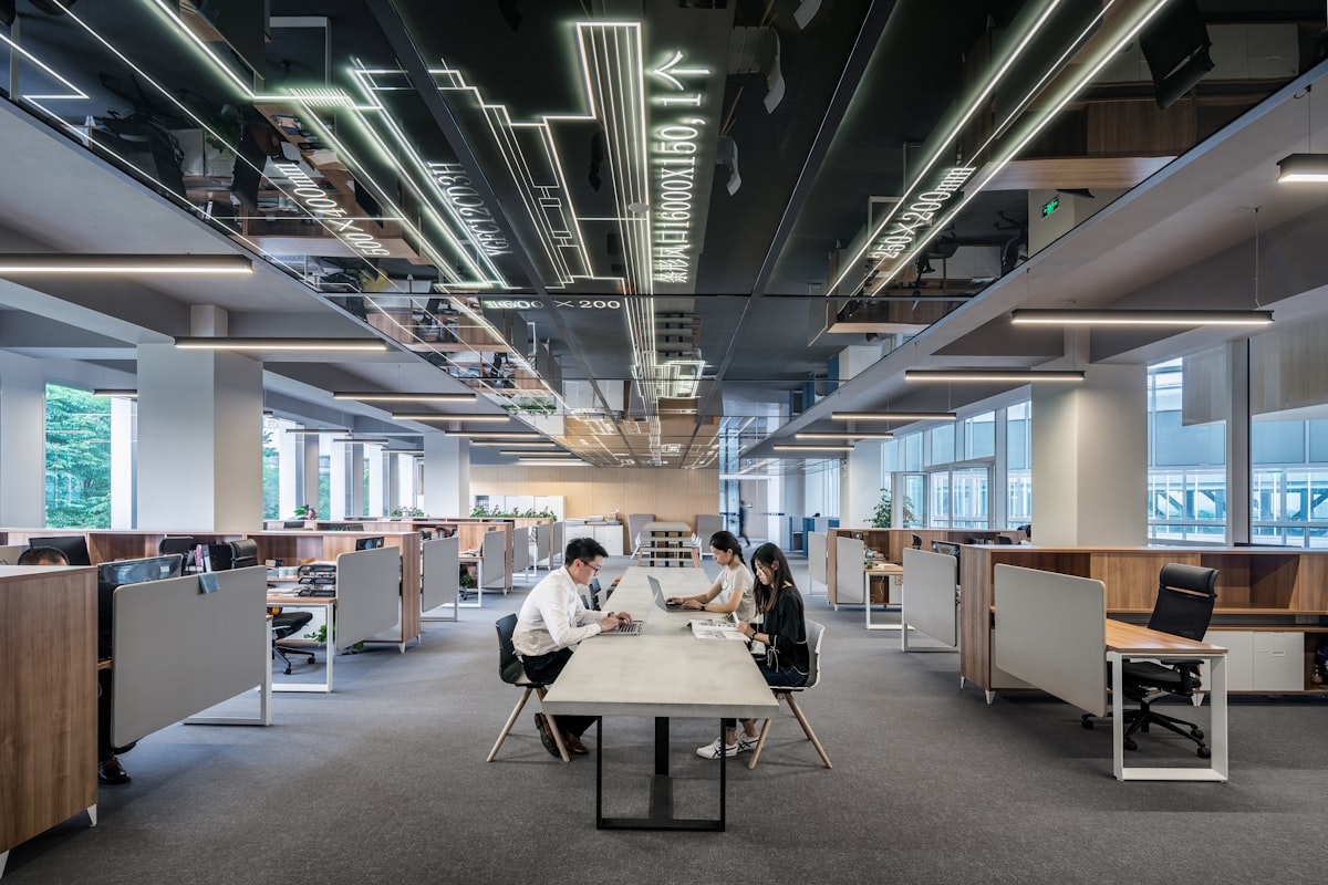 Three colleagues collaborating in an open office