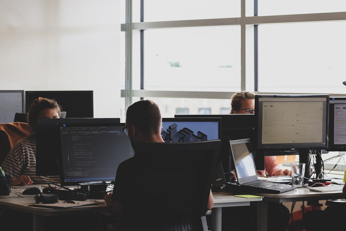 A development team working at their monitors